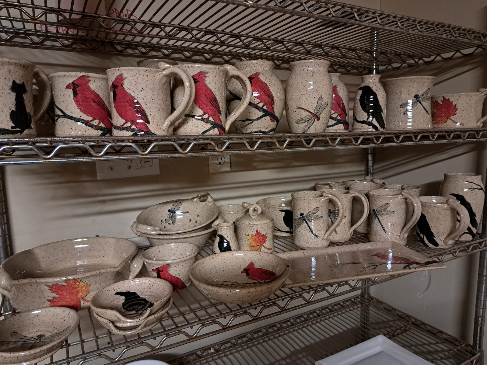 Hand-painted bird pottery on display